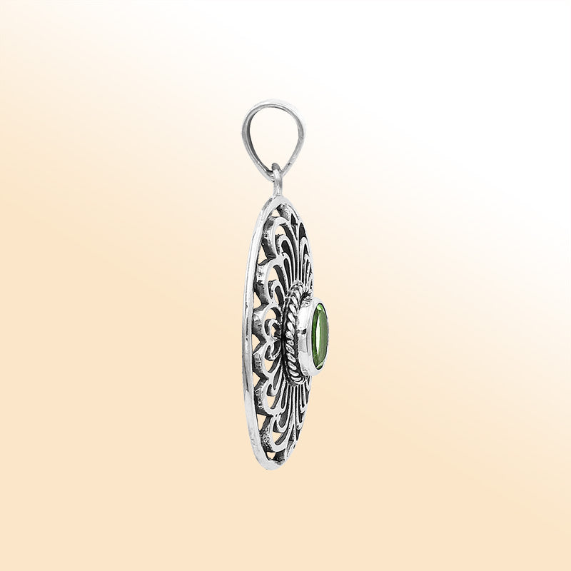Elegant sterling silver oval pendant featuring Peridot Quartz with handcrafted Balinese filigree detailing and polished silver finish.