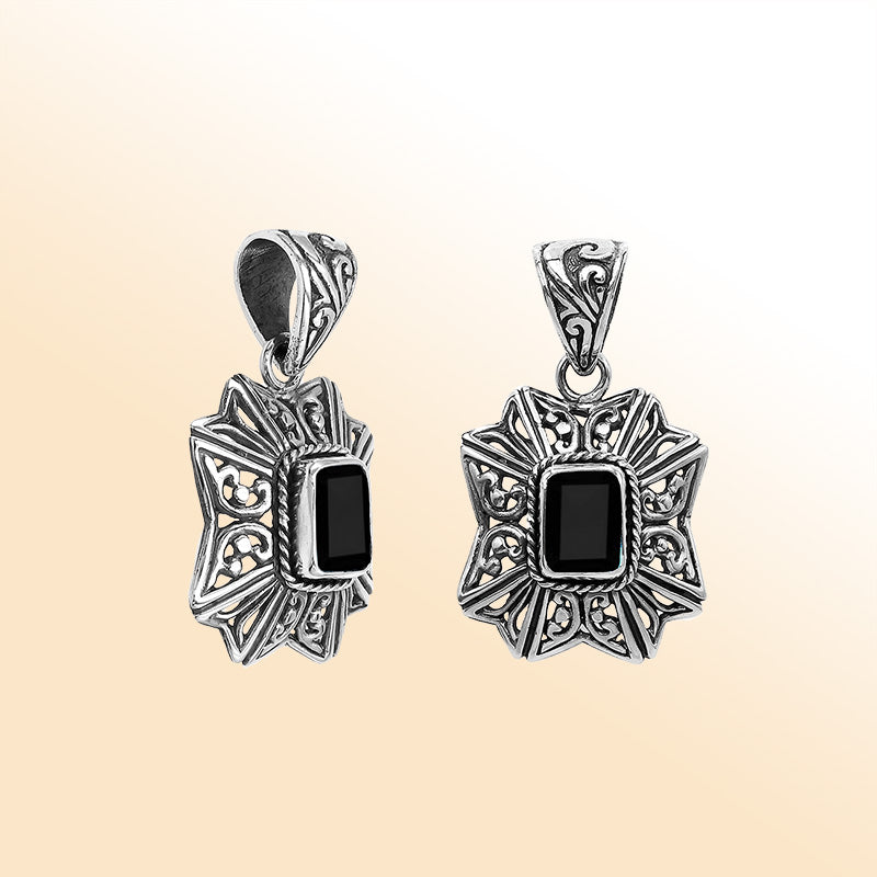 Elegant sterling silver radiant star pendant featuring Black Onyx centerpiece with artistic filigree detailing and high-gloss finish.