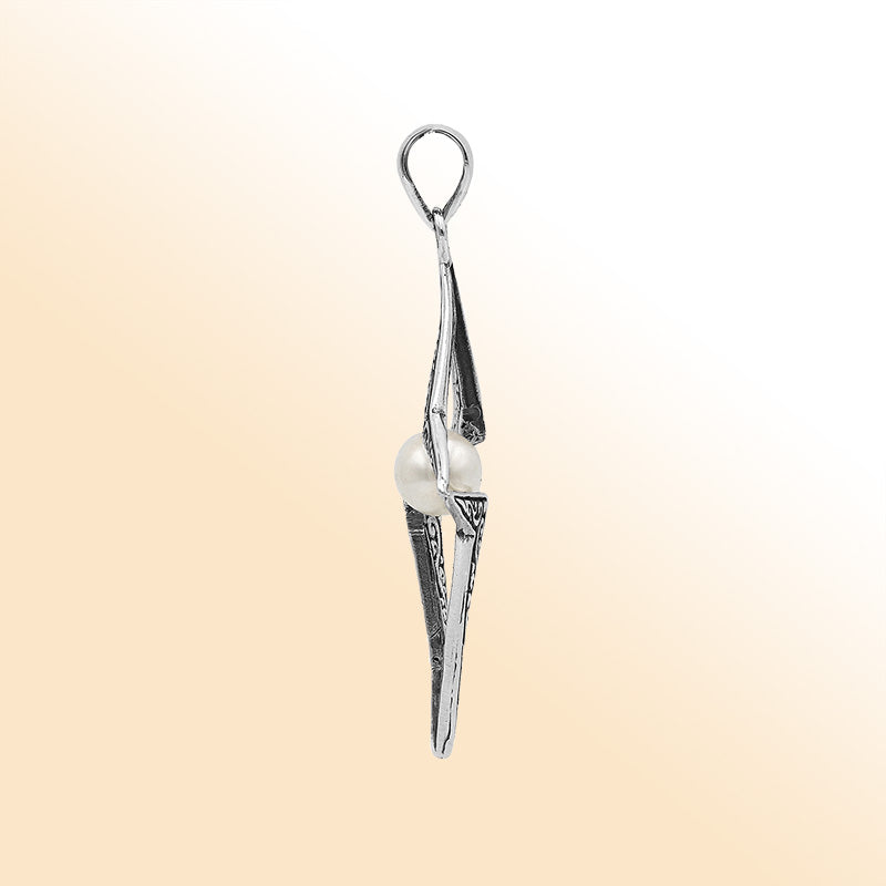Elegant sterling silver radiant star pendant featuring White Pearl centerpiece with artistic filigree detailing and polished finish.