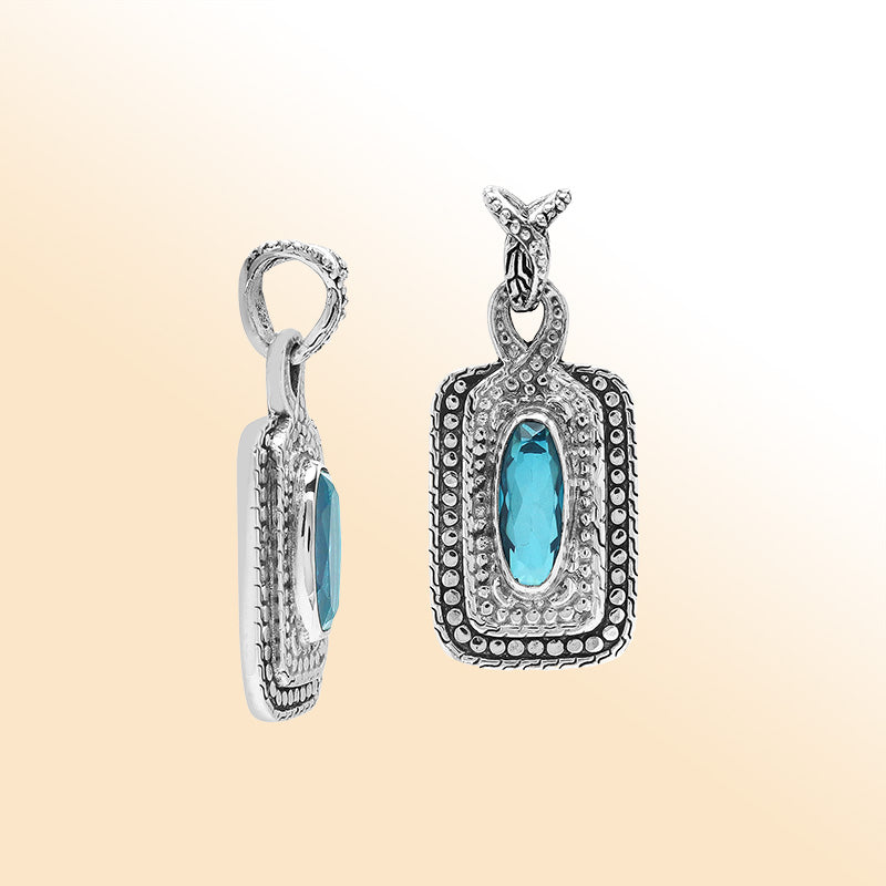 Elegant sterling silver oval pendant featuring Blue Topaz Quartz center with artistic beaded frame and polished silver finish.