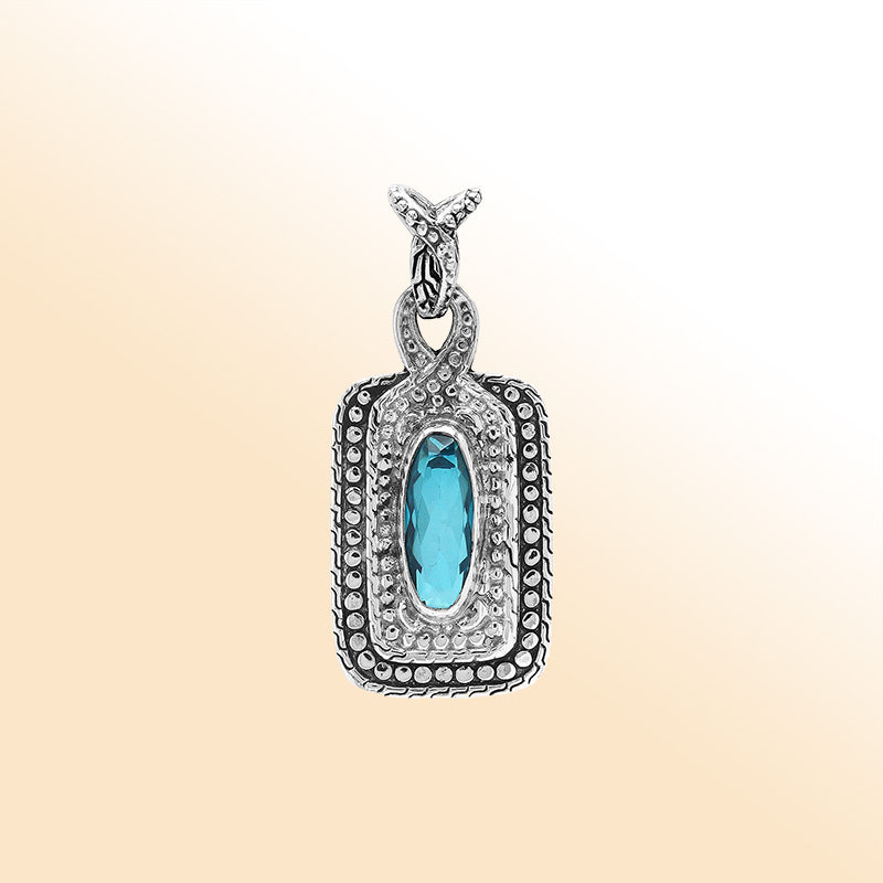 Elegant sterling silver oval pendant featuring Blue Topaz Quartz center with artistic beaded frame and polished silver finish.