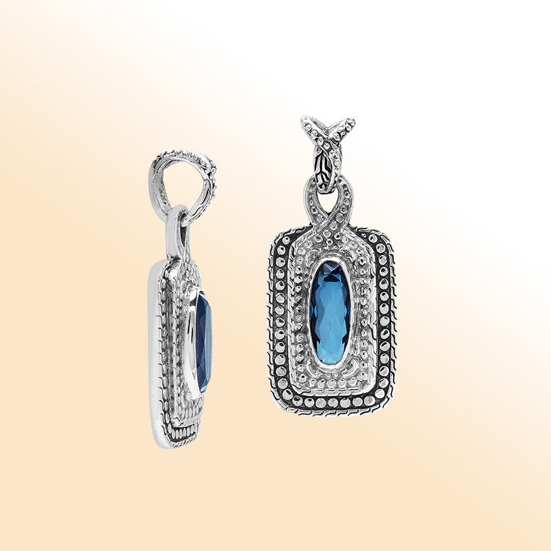 Elegant sterling silver oval pendant featuring London Blue Topaz Quartz center with artistic beaded frame and polished finish.