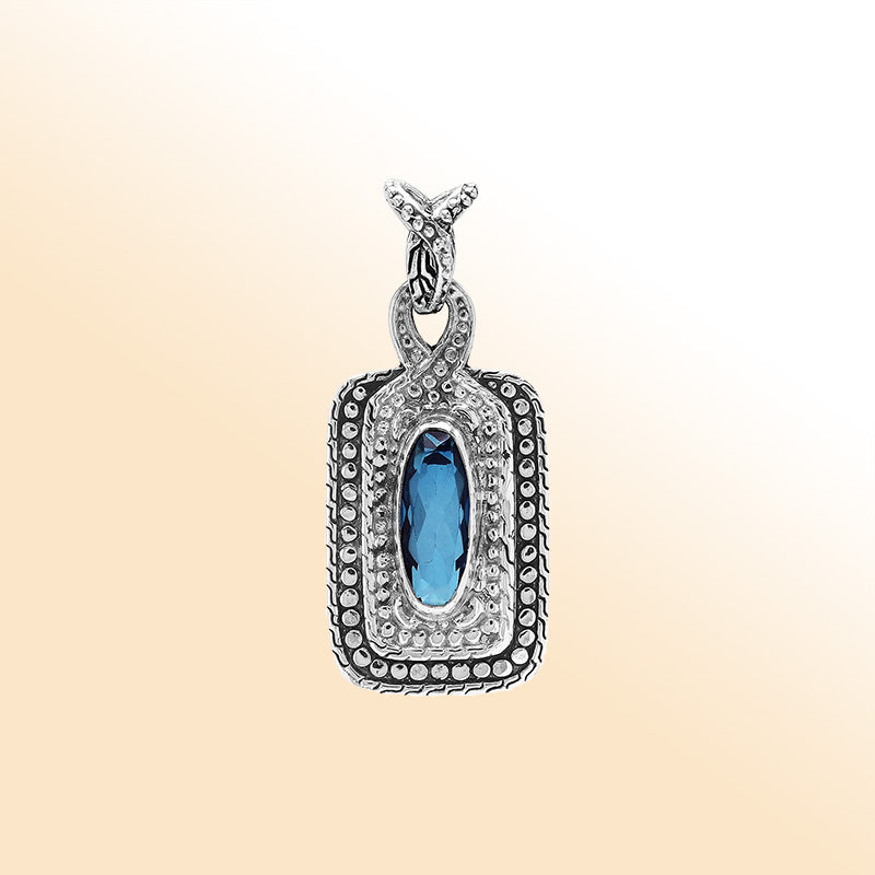 Elegant sterling silver oval pendant featuring London Blue Topaz Quartz center with artistic beaded frame and polished finish.