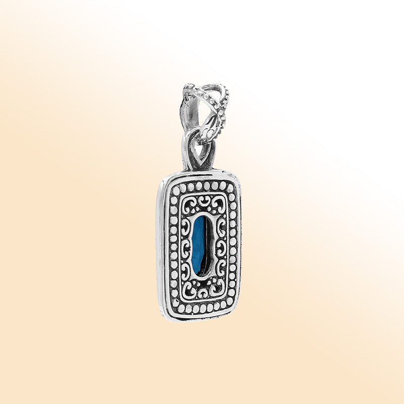 Elegant sterling silver oval pendant featuring London Blue Topaz Quartz center with artistic beaded frame and polished finish.