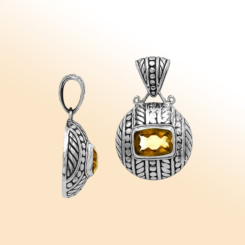 Elegant sterling silver pendant with cushion citrine quartz centerpiece, artistic leaf engravings, and smooth polished finish crafted in Balinese design tradition.