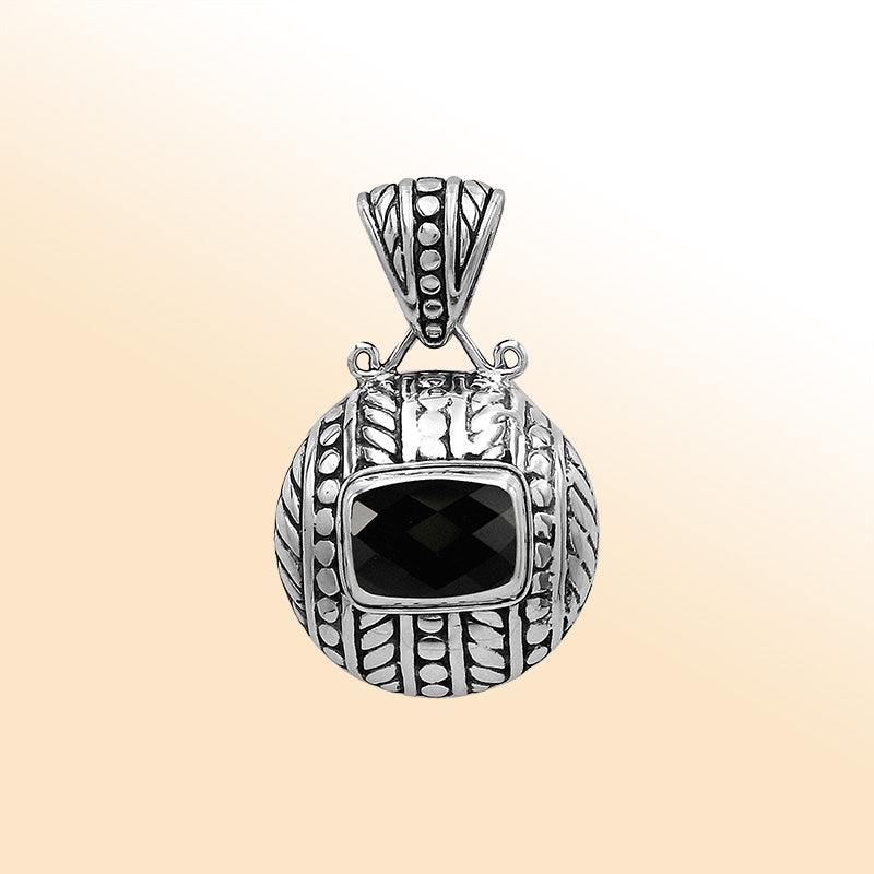 Handcrafted sterling silver pendant with cushion black onyx quartz, detailed leaf engravings, dotted textures, and high-polish finish reflecting Balinese craftsmanship.
