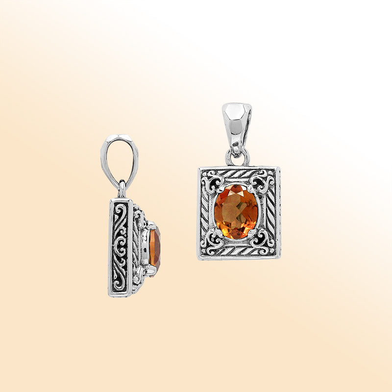 Handcrafted sterling silver pendant with oval citrine quartz, detailed swirl engraving, and mirror-polished surface showcasing Balinese artistry.
