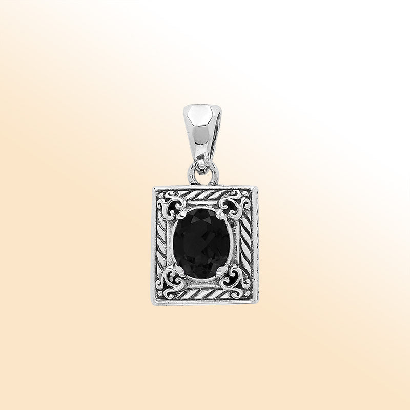Handcrafted sterling silver pendant featuring oval black onyx quartz, ornate swirl engravings, and smooth polished finish showcasing modern Balinese artistry.