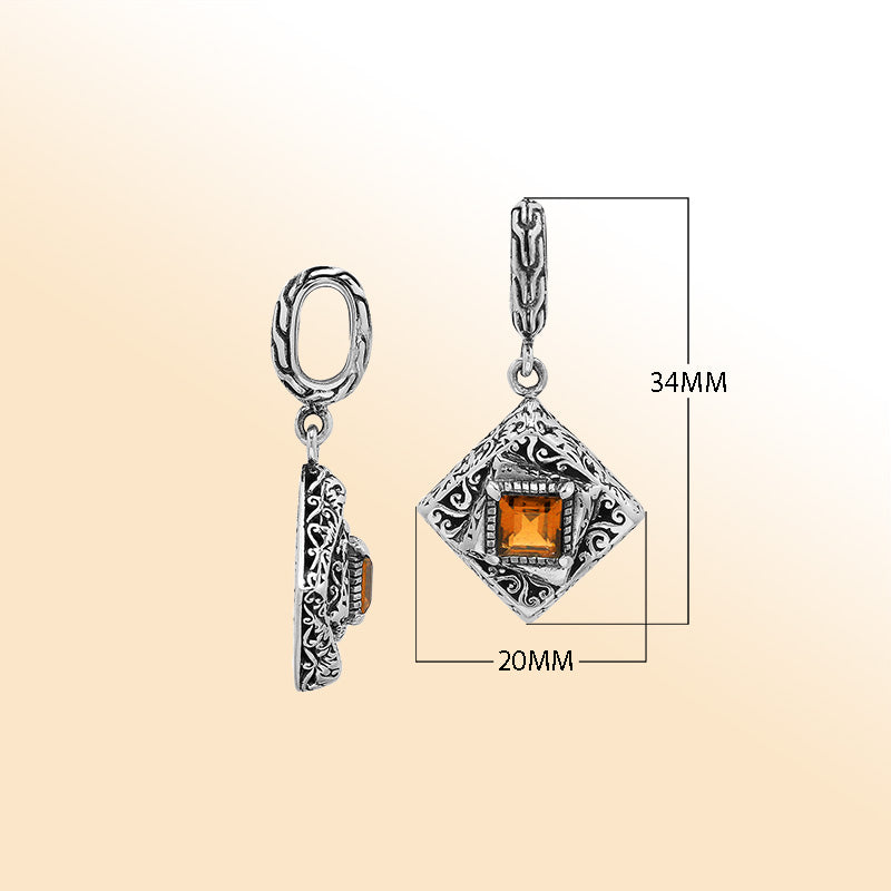 Handcrafted sterling silver pendant with square citrine quartz centerpiece, artistic filigree engravings, and polished finish reflecting Balinese craftsmanship.