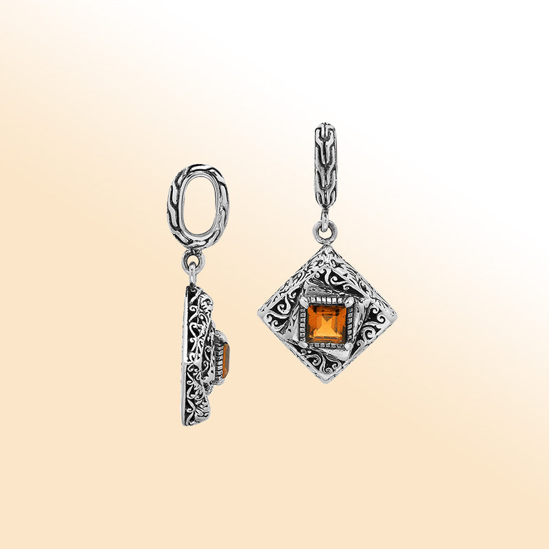 Handcrafted sterling silver pendant with square citrine quartz centerpiece, artistic filigree engravings, and polished finish reflecting Balinese craftsmanship.