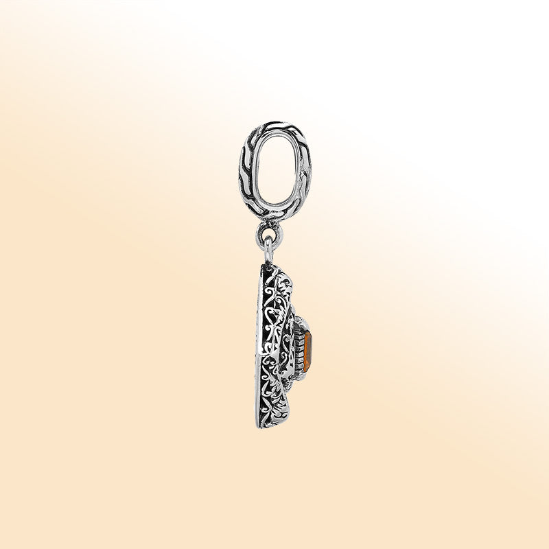 Handcrafted sterling silver pendant with square citrine quartz centerpiece, artistic filigree engravings, and polished finish reflecting Balinese craftsmanship.
