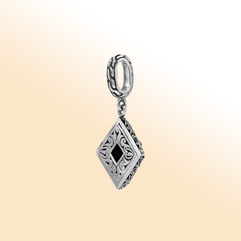 Handcrafted sterling silver pendant with square citrine quartz centerpiece, artistic filigree engravings, and polished finish reflecting Balinese craftsmanship.