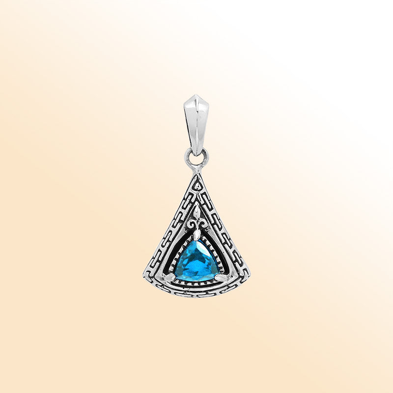 Handcrafted sterling silver triangular pendant with trillion-cut blue topaz quartz, geometric engravings, and high-gloss polished Balinese detailing.