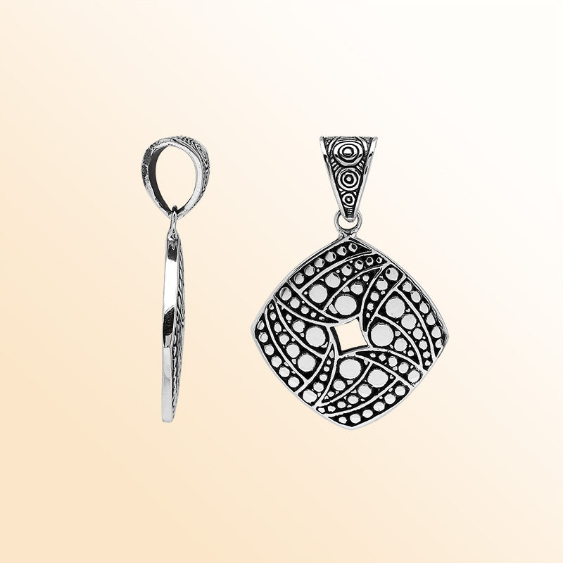 Handcrafted sterling silver diamond-shaped pendant with circular dot engravings, oxidized details, and polished Balinese geometric pattern.