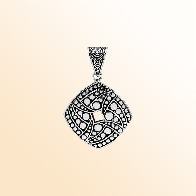 Handcrafted sterling silver diamond-shaped pendant with circular dot engravings, oxidized details, and polished Balinese geometric pattern.