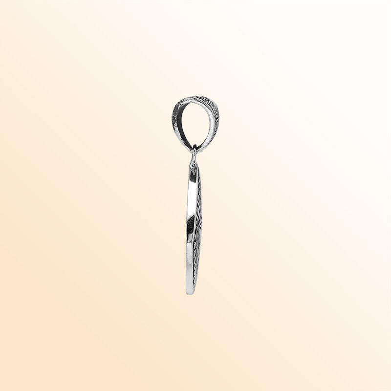 Handcrafted sterling silver diamond-shaped pendant with circular dot engravings, oxidized details, and polished Balinese geometric pattern.