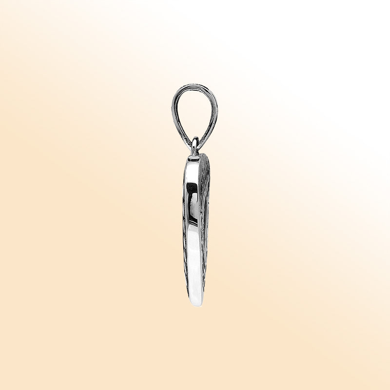 Handcrafted sterling silver heart-shaped pendant with layered open-heart design, dotted engravings, and oxidized Balinese detailing.