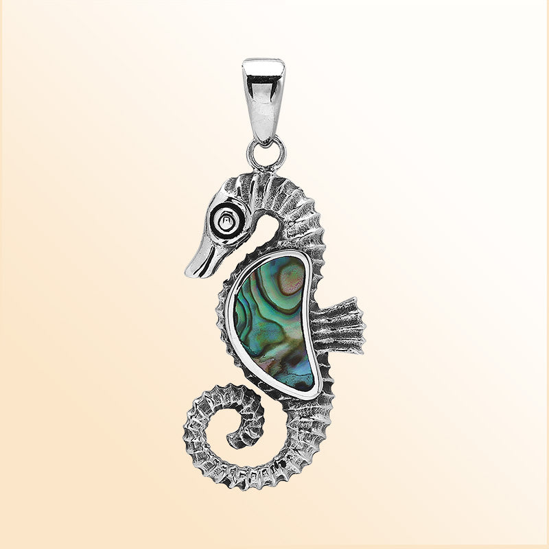 Handcrafted sterling silver seahorse pendant with Abalone Shell, polished surface, and artistic Balinese detailing.