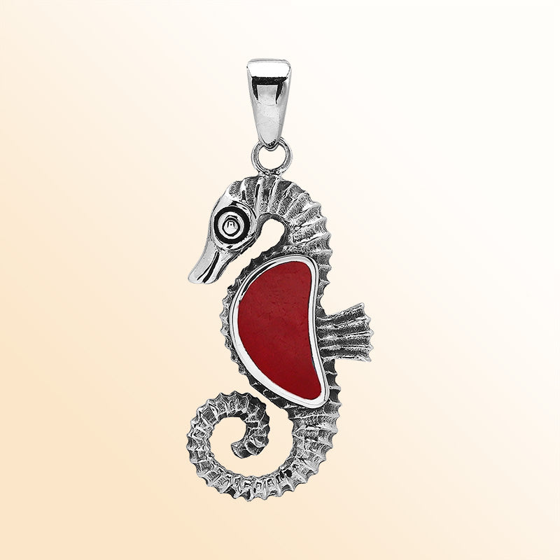 Handcrafted sterling silver seahorse pendant with vibrant Red Coral, polished surface, and artistic Balinese detailing.