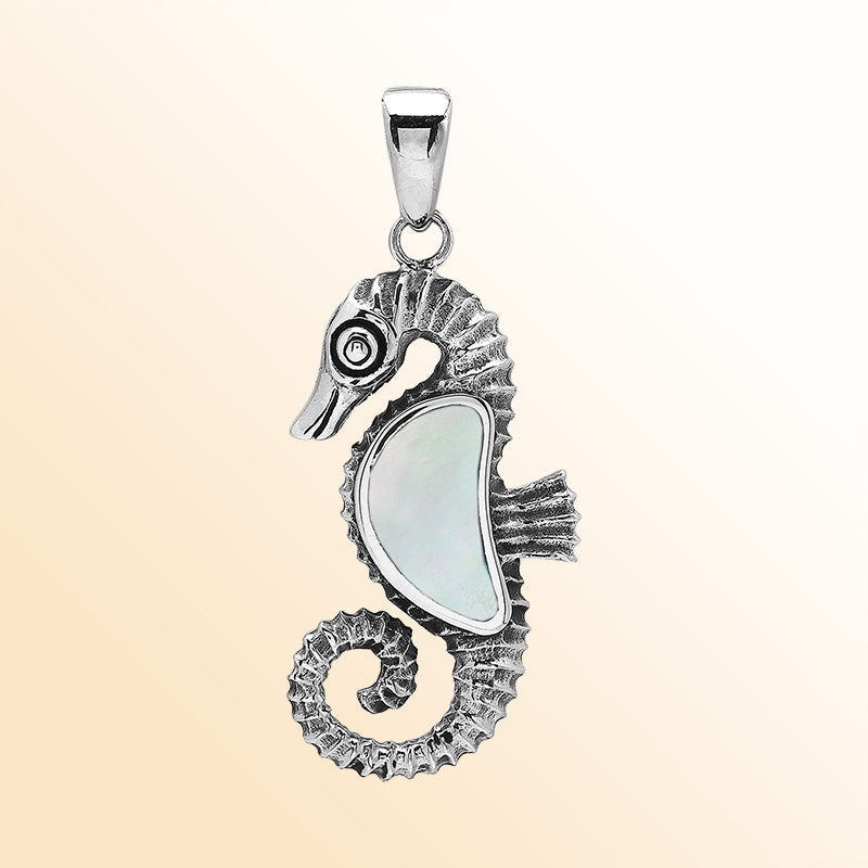 Handcrafted sterling silver seahorse pendant with lustrous Mother Of Pearl and polished Balinese design detailing.