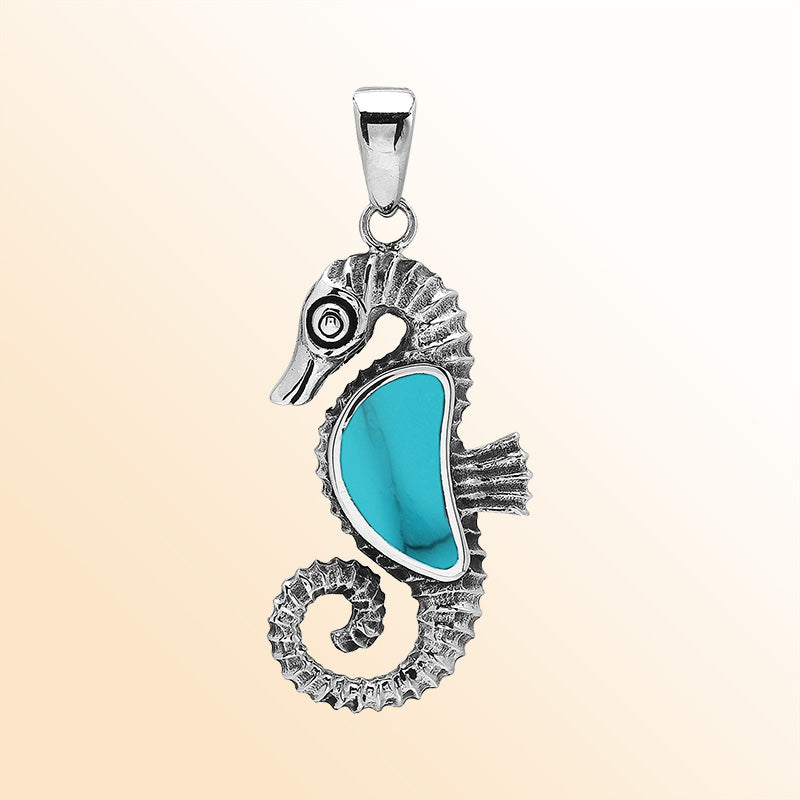 Handcrafted sterling silver seahorse pendant featuring turquoise shell and Balinese artistry with a polished finish.