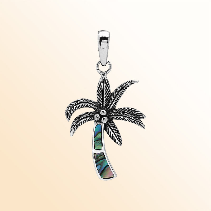 Elegant sterling silver palm tree pendant with shimmering abalone shell and Balinese craftsmanship in polished finish.