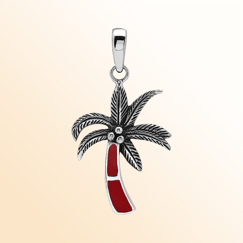 Elegant sterling silver palm tree pendant with red coral inlay and Balinese craftsmanship in a polished finish.