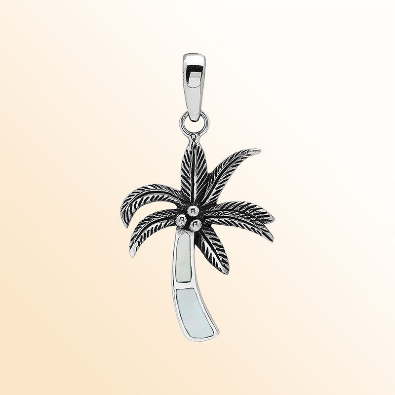 Elegant sterling silver palm tree pendant with mother of pearl inlay and Balinese craftsmanship in polished high-gloss finish.