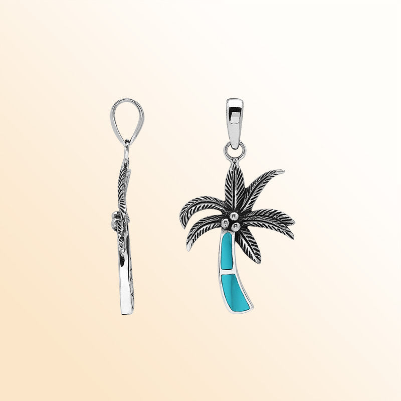 Elegant sterling silver palm tree pendant with turquoise shell inlay and Balinese craftsmanship in polished finish.