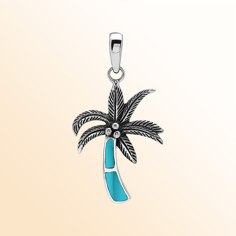 Elegant sterling silver palm tree pendant with turquoise shell inlay and Balinese craftsmanship in polished finish.