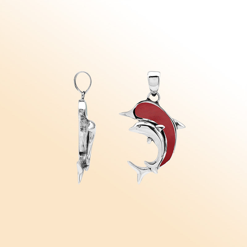 Elegant sterling silver dolphin pendant with red coral inlay and Balinese craftsmanship in a high-polish ocean-inspired design.