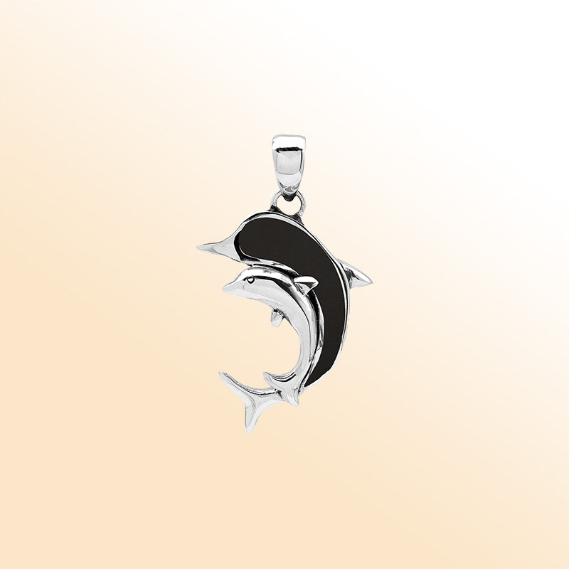 Elegant sterling silver dolphin pendant with black shell inlay and Balinese craftsmanship in a polished ocean-inspired design.