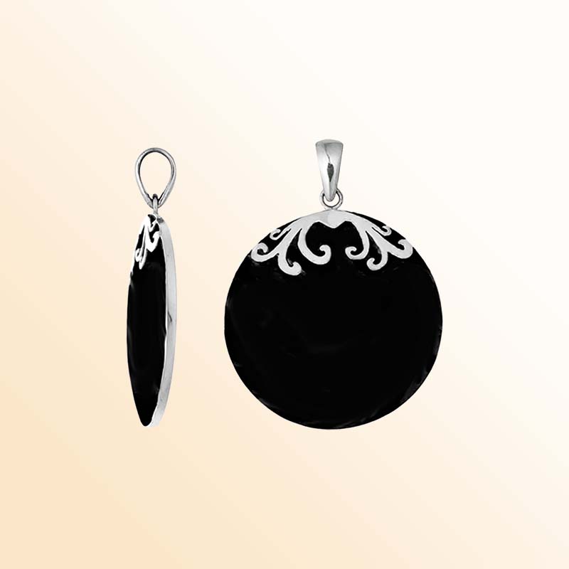 Elegant sterling silver circular pendant showcasing a glossy midnight-black shell, delicate symmetrical silver floral scroll accents crowning the upper edge, smooth rounded edges, and a beautifully polished hanging bail.
