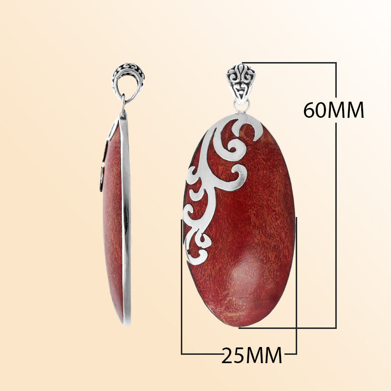 Elegant handcrafted sterling silver pendant with Red Coral and vine-inspired detailing.