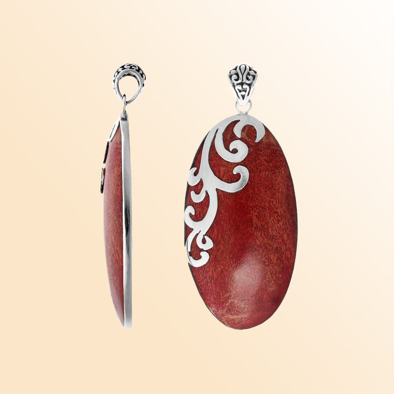 Artisan sterling silver pendant with vibrant Red Coral and flowing swirl accents in a polished finish.