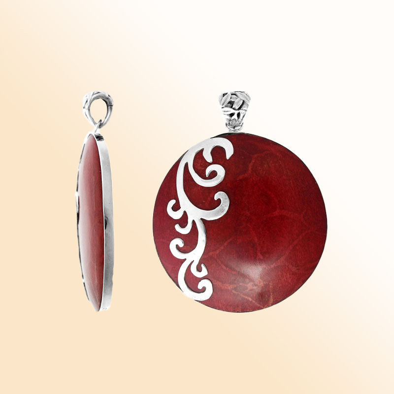 Artisan sterling silver pendant with vibrant Red Coral and flowing swirl accents in a polished finish.