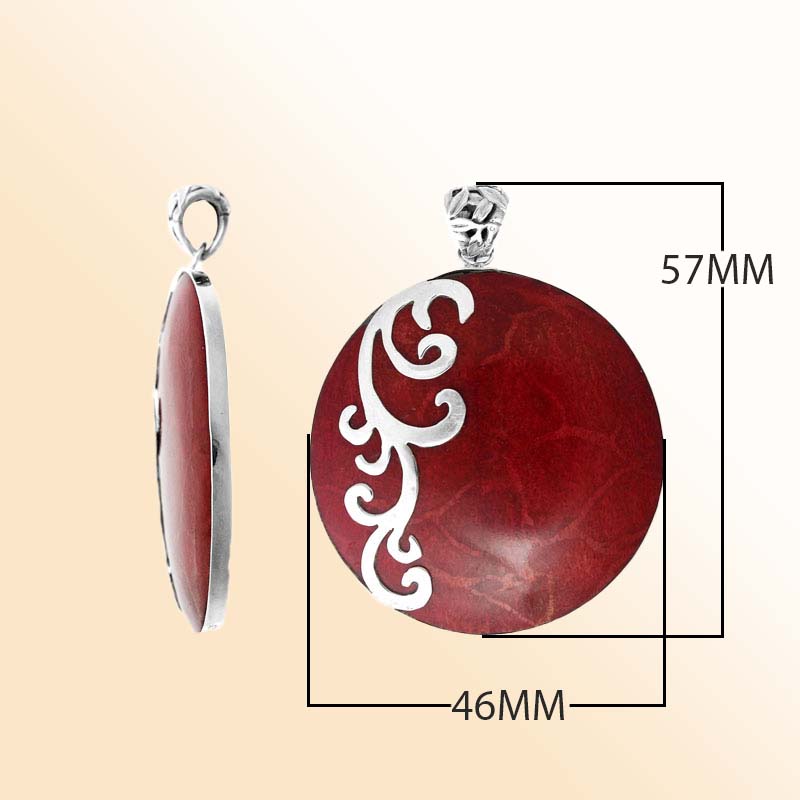 Artisan sterling silver pendant with vibrant Red Coral and flowing swirl accents in a polished finish.
