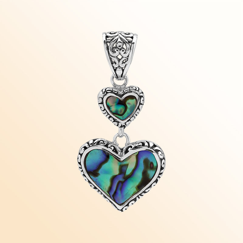 Artisan sterling silver pendant featuring Abalone Shell double hearts with Balinese accents.