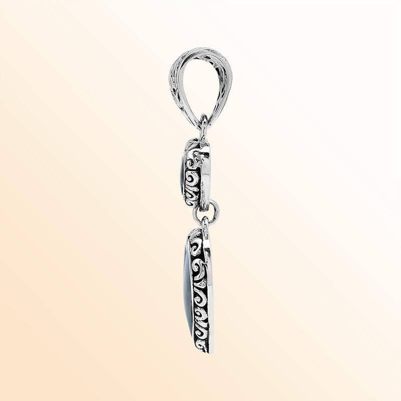 Artisan sterling silver pendant featuring Abalone Shell double hearts with Balinese accents.