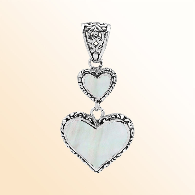 Artisan sterling silver double heart pendant with Mother of Pearl and Balinese accents.
