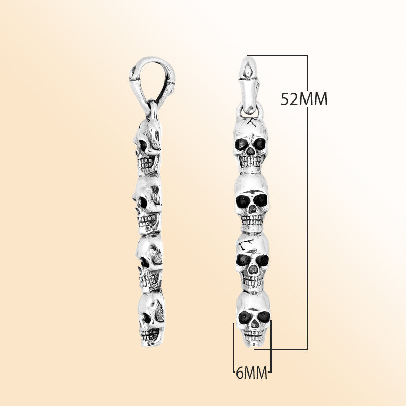 Artisan sterling silver vertical skull pendant with carved detailing and polished finish.