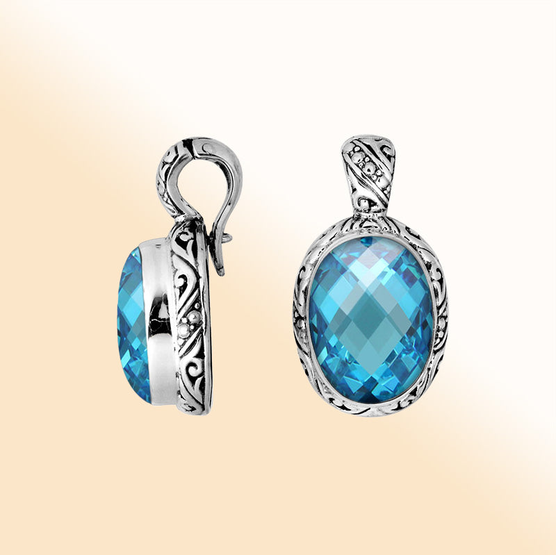 Handcrafted sterling silver oval pendant featuring faceted Blue Topaz Quartz with decorative Balinese accents.