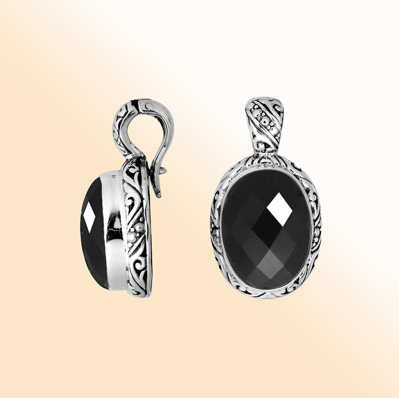 Handcrafted sterling silver pendant featuring a faceted Black Onyx framed with artistic Balinese details and a polished high-gloss finish.