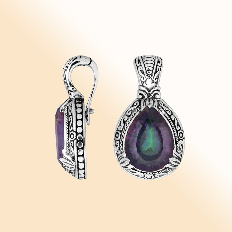 Handcrafted sterling silver pendant featuring a teardrop Mystic Quartz with artistic Balinese detailing and a bright polished finish.