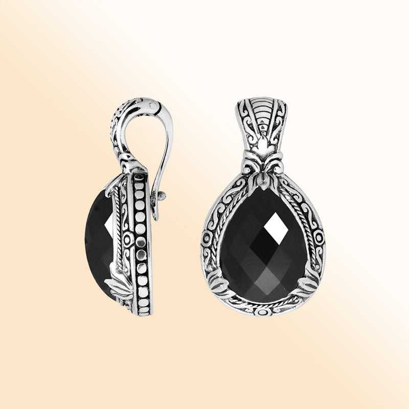 Handcrafted sterling silver pendant featuring a faceted Black Onyx teardrop with artistic Balinese detailing and a polished high-gloss surface.