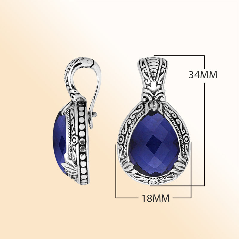 Handcrafted sterling silver pendant featuring a faceted Sapphire Quartz teardrop with artistic Balinese detailing and a polished high-gloss surface.