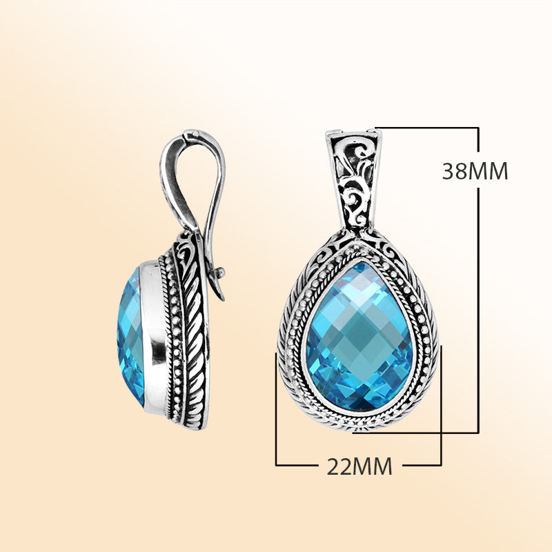 Handcrafted sterling silver teardrop pendant featuring Blue Topaz Quartz with artistic Balinese detailing and a polished high-gloss finish.