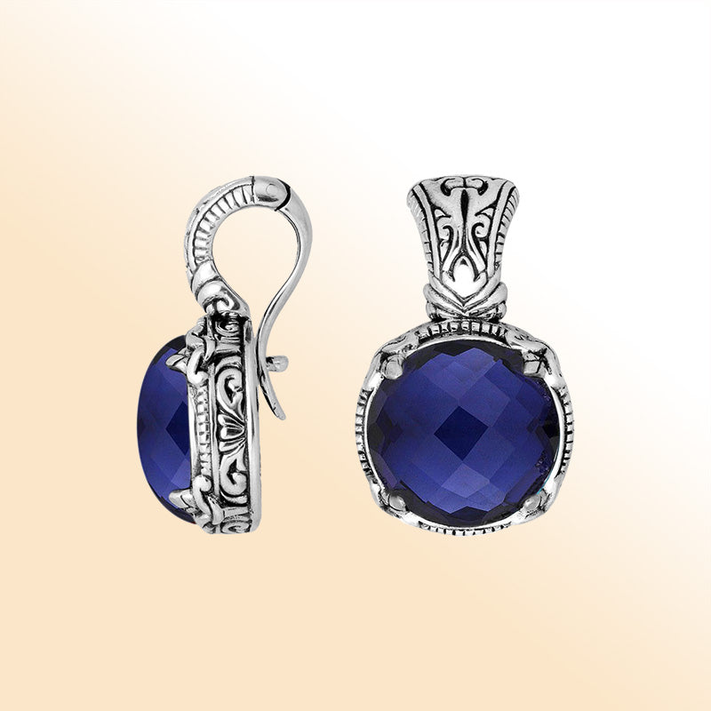 Handcrafted sterling silver cushion pendant featuring deep Sapphire Quartz and artistic Balinese detailing.