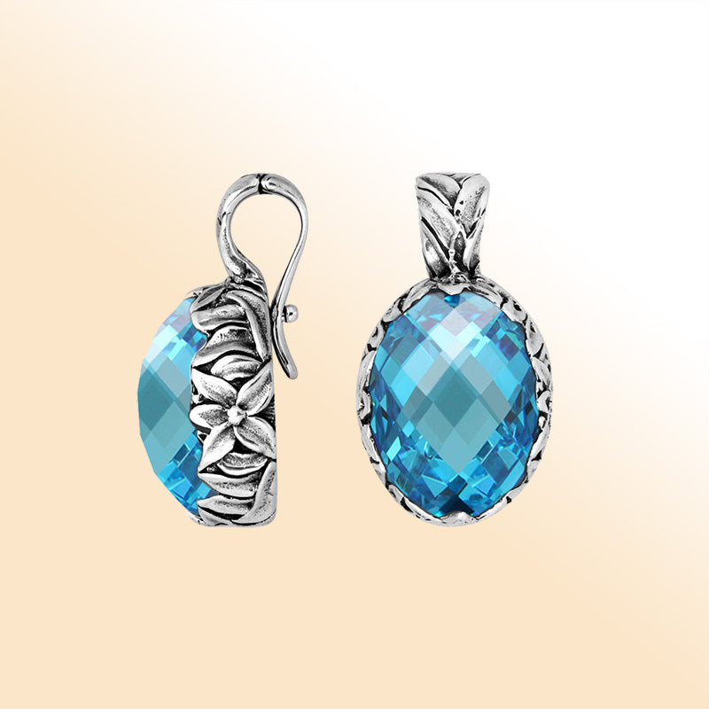 Elegant sterling silver oval-shaped Blue Topaz Quartz pendant with engraved floral detailing and enhancer bail, mirror-polished for modern elegance and timeless sophistication.