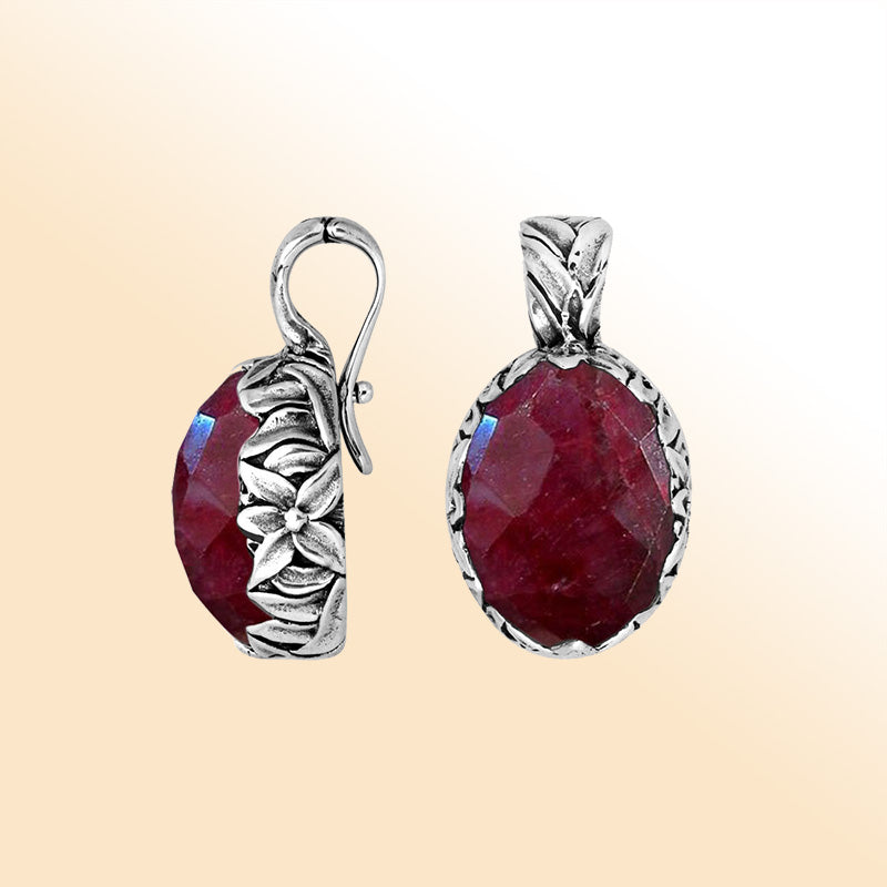 Handcrafted sterling silver oval pendant featuring faceted Ruby Quartz with artistic Balinese floral detailing.
